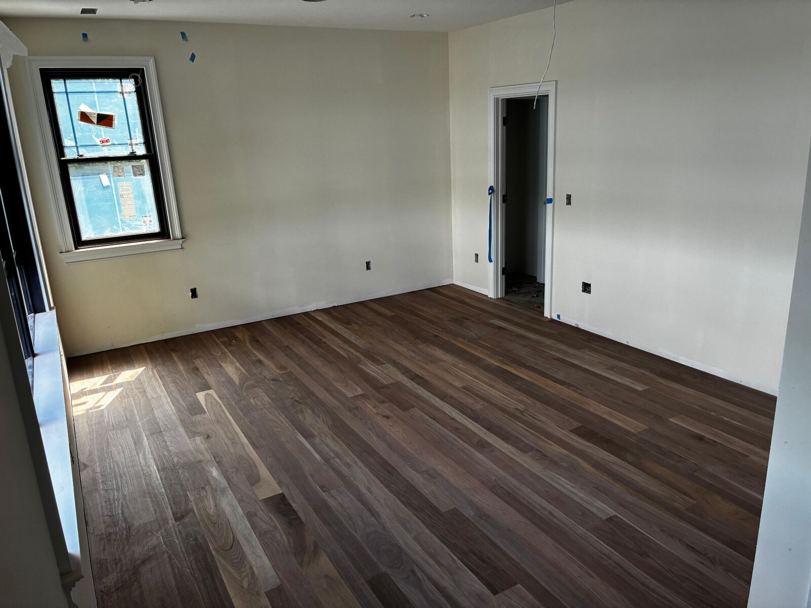 Completed wood flooring installation in large residential room